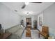 Bright living room with a comfortable sofa, accent chairs, and an open doorway to another room at 1010 E Fern St, Tampa, FL 33604