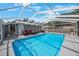 Sparkling screened-in pool with ample space for lounging and relaxation, enhancing the backyard's appeal at 1010 E Fern St, Tampa, FL 33604