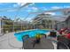 Stunning screened-in pool with patio furniture, creating an inviting outdoor living space for relaxation and entertainment at 1010 E Fern St, Tampa, FL 33604