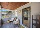 Inviting porch with stylish seating, a wood plank ceiling, and secure front door at 1010 E Fern St, Tampa, FL 33604