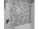 Modern shower with decorative tile and contemporary fixtures, adding a touch of elegance at 1010 E Fern St, Tampa, FL 33604