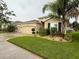 Charming single-story home featuring a well-manicured lawn and a two-car garage at 10747 Laxer Cay Loop, San Antonio, FL 33576