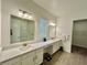 Contemporary bathroom featuring dual sinks, quartz counters and a large vanity mirror at 10864 Banyan Breeze Blvd, Land O Lakes, FL 34638