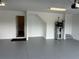 Spacious garage with white walls, grey sealed floors, a water heater, and access to the house at 10864 Banyan Breeze Blvd, Land O Lakes, FL 34638