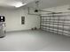 Clean and spacious two-car garage with sealed flooring and an electric door opener at 10864 Banyan Breeze Blvd, Land O Lakes, FL 34638