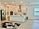 Spacious open concept kitchen with stainless appliances, white cabinets, and a center island at 10864 Banyan Breeze Blvd, Land O Lakes, FL 34638