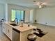 Open concept kitchen with large island, stainless dishwasher and sink, leading to living room at 10864 Banyan Breeze Blvd, Land O Lakes, FL 34638