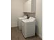 Bright laundry room with white washer, dryer, and overhead cabinets for storage at 10864 Banyan Breeze Blvd, Land O Lakes, FL 34638