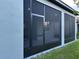 Screened-in patio with an entry door, offering an ideal space for outdoor dining and relaxation at 10864 Banyan Breeze Blvd, Land O Lakes, FL 34638