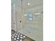 Modern shower with white subway tile surround, glass partition and a built-in bench at 10864 Banyan Breeze Blvd, Land O Lakes, FL 34638