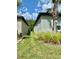 Well-maintained side yard with green grass and manicured landscaping at 10864 Banyan Breeze Blvd, Land O Lakes, FL 34638