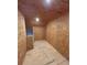 Unfinished storage room with plywood walls and flooring, showcasing ample space at 10864 Banyan Breeze Blvd, Land O Lakes, FL 34638