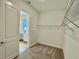 Spacious walk-in closet with carpet floors and wire shelving for optimal organization at 10864 Banyan Breeze Blvd, Land O Lakes, FL 34638