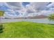 Expansive backyard with lush green grass and a privacy fence at 10915 Kirkwall Port Dr, Wimauma, FL 33598