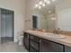 Bathroom featuring double vanity, mirrors and shower, plus a toilet at 10915 Kirkwall Port Dr, Wimauma, FL 33598