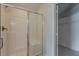 Bright bathroom featuring a glass-enclosed shower and an open closet at 10915 Kirkwall Port Dr, Wimauma, FL 33598
