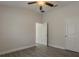 Bedroom featuring wood-look tile floors, doors, and access to the bathroom at 10915 Kirkwall Port Dr, Wimauma, FL 33598