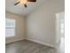 Bedroom with wood-look tile floors, a window, and access to the bathroom at 10915 Kirkwall Port Dr, Wimauma, FL 33598