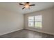 Bedroom showcasing wood-look tile floors and a large window at 10915 Kirkwall Port Dr, Wimauma, FL 33598