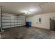 Spacious two car garage features concrete flooring and a water heater at 10915 Kirkwall Port Dr, Wimauma, FL 33598