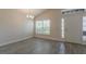 Bright room with wood-look tile, and a chandelier at 10915 Kirkwall Port Dr, Wimauma, FL 33598