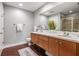 Bathroom boasts a double sink vanity, modern fixtures, and wood-look tile flooring at 1120 E Kennedy Blvd # 912, Tampa, FL 33602