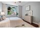 A modern bedroom featuring hardwood floors, a large window with a view, and neutral color tones at 1120 E Kennedy Blvd # 912, Tampa, FL 33602