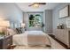 Inviting bedroom featuring a large window, modern decor, hardwood floors, and a comfortable bed at 1120 E Kennedy Blvd # 912, Tampa, FL 33602