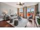 Bright living room featuring a ceiling fan, neutral-toned walls, hardwood floors, and large windows with city views at 1120 E Kennedy Blvd # 912, Tampa, FL 33602