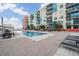Inviting swimming pool surrounded by lounge chairs and tropical plants, perfect for relaxation outside modern condos at 1120 E Kennedy Blvd # 912, Tampa, FL 33602