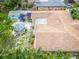 An aerial view showcases backyard with a gazebo, patio furniture, tropical foliage, and a storage shed at 113 Maplewood Ave, Clearwater, FL 33765