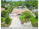 Aerial view of the home featuring mature trees, manicured landscaping, and a welcoming front porch at 113 Maplewood Ave, Clearwater, FL 33765