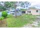 Spacious backyard featuring a gazebo, shed, and well-maintained lawn, perfect for outdoor activities and relaxation at 113 Maplewood Ave, Clearwater, FL 33765