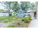 Backyard oasis featuring a charming gazebo, mature trees, manicured landscaping, and a privacy fence for secluded enjoyment at 113 Maplewood Ave, Clearwater, FL 33765