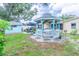 Charming backyard featuring a gazebo, shed, and lush greenery, creating a serene and inviting outdoor space at 113 Maplewood Ave, Clearwater, FL 33765