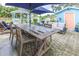 Backyard patio featuring a dining set and lounge area, complemented by a picturesque gazebo and shed at 113 Maplewood Ave, Clearwater, FL 33765