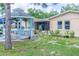 Cozy backyard with a gazebo and screened-in patio, surrounded by lush greenery and offering a relaxing outdoor space at 113 Maplewood Ave, Clearwater, FL 33765