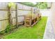 A fenced yard features raised planting beds and grassy area at 113 Maplewood Ave, Clearwater, FL 33765