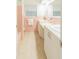 Retro pink bathroom features a double sink vanity and unique tile work, creating a charming and nostalgic space at 113 Maplewood Ave, Clearwater, FL 33765