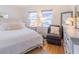 Bright bedroom featuring hardwood floors, white walls, and lots of natural light from two windows at 113 Maplewood Ave, Clearwater, FL 33765