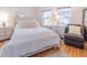 Cozy bedroom with hardwood floors, neutral decor, and bright natural light, creating a peaceful and inviting space at 113 Maplewood Ave, Clearwater, FL 33765