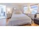 Bright bedroom features hardwood floors, neutral paint, bedside tables and door to an adjacent room at 113 Maplewood Ave, Clearwater, FL 33765