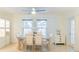 Bright dining room featuring a ceiling fan, tile floor, and natural light from the large windows at 113 Maplewood Ave, Clearwater, FL 33765