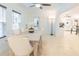 Elegant dining area featuring a modern table, chairs, and ample natural light from large windows at 113 Maplewood Ave, Clearwater, FL 33765