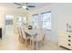 Bright dining room with a modern table, upholstered chairs, and ample natural light at 113 Maplewood Ave, Clearwater, FL 33765