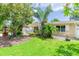 Single-story home featuring a well-maintained lawn, mature landscaping, and charming curb appeal at 113 Maplewood Ave, Clearwater, FL 33765