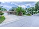 Well-manicured property featuring a long driveway and mature landscaping at 113 Maplewood Ave, Clearwater, FL 33765