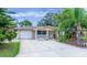 Beautiful home with an attached garage, front porch, and lush landscaping at 113 Maplewood Ave, Clearwater, FL 33765