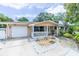 Charming single-story home featuring an attached garage, well-maintained lawn, and inviting porch at 113 Maplewood Ave, Clearwater, FL 33765