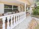 Charming front porch with stone floors and classic white railing at 113 Maplewood Ave, Clearwater, FL 33765